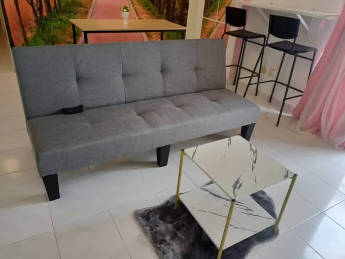 The living area at Sakura Home, with sofa and breakfast bar